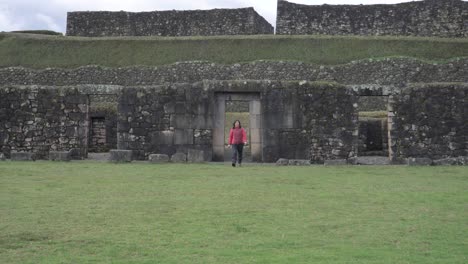 Woman-walking-in-the-last-fortress-of-the-inca-empire,-vitcos,-tupac-amaru,-inca-culture,-peru