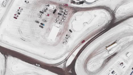 Sannidal,-Telemark-County,-Norway---Cars-Near-the-Snow-covered-Alti-Kragero-Shopping-Mall-on-a-Winter-Day---Aerial-Drone-Shot