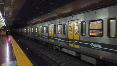 Yellow-vintage-train-railway-arrives-in-underground-subway-station,-buenos-aires-argentina-Subte-public-transportation