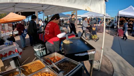 Vendor-making-quesadilla-on-portable-griddle-and-placing-it-on-plate