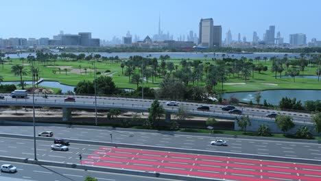 Dubai-skyline-view-from-Deira-as-traffic-flows-on-the-Airport-Road-in-Dubai,-United-Arab-Emirates