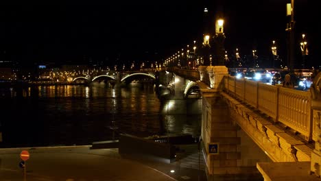 Budapest-city-center-view-with-Margit-Bridge-and-Danube-river-at-night,-light-reflections,-traffic-moving,-wide-shot