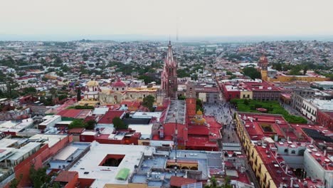 Aerial-View-Over-Cityscape-With-Parroquia-De-San-Miguel-Arcángel-In-San-Miguel-De-Allende,-Mexico---Drone-Shot