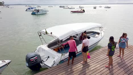 People-boarding-a-motor-boat-in-the-port-of-Bahia,-Brazil