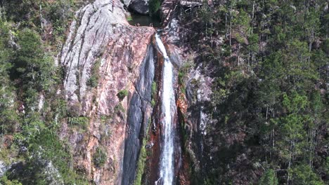 People-relaxing-in-natural-pool-of-Salto-de-Aguas-Blancas-waterfall,-Constanza-in-Dominican-Republic