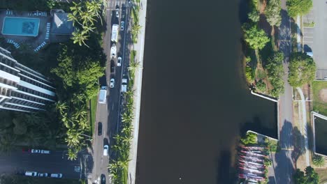 Ala-Wai-waterway-in-Honolulu,-top-down-aerial-view,-tilt-up-reveals-cityscape
