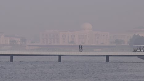 On-February-24,-2024,-residents-take-a-walk-on-a-misty-winter-morning-along-the-coastline-of-Sharjah-in-the-United-Arab-Emirates