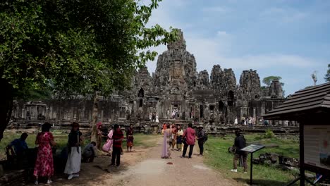 Tourists-take-selfies-and-photos-against-the-stunning-Angkor-Wat-temple-backdrop,-blending-modern-technology-with-ancient-beauty-in-a-picturesque-scene-of-cultural-exploration-and-documentation
