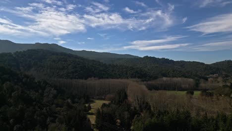 Drone-Landscape-of-Mountain-Range-Green-Hills-in-Catalonia-Spain,-Environmental-Pristine-Mediterranean-Mountain-Range-with-Native-Trees,-Morning-Clear-Daylight-skyline