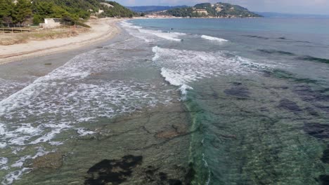 Video-in-slow-motion-demonstrating-waves-splashing-on-the-beach-in-Posidi,-Chalkidiki,-Greece