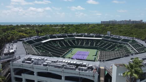 Miami,-Florida,-USA,-Drohnen-Luftaufnahme-Des-Key-Biscayne-Tennisstadions-Und-Leute,-Die-Vor-Leeren-Tribünen-Doppel-Spielen