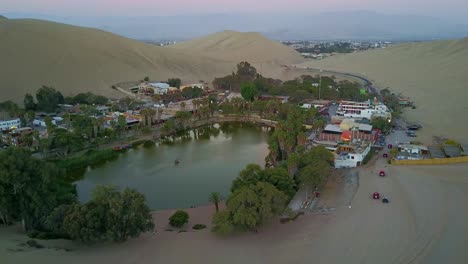 Aerial-Drone-Shot-Over-Huacachina-Oasis-in-the-Desert-with-a-Pull-Out-Shot,-Peru,-South-America