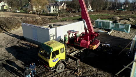 Mobile-Crane-And-Workers-At-Modular-Housing-Project