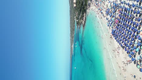 Aerial-beach-scene-on-sunny-summer-day-at-La-Pelosa,-Sardinia