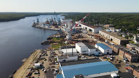 Slow-aerial-descent-of-Bath-Iron-Works,-showing-the-Kennebec-River
