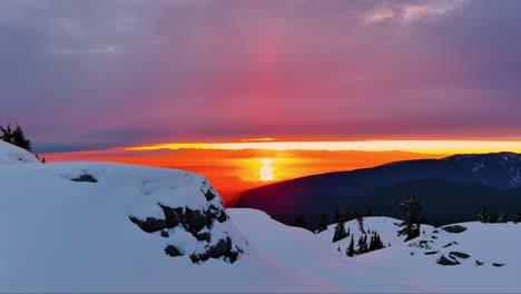 Snow-covered-peak,-dramatic-sunset-sky