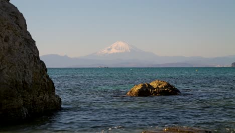 Low-angle-shot-at-beach-with-rocks-and-Mt-Fuji-in-distance