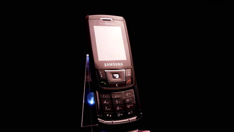 Samsung-SGH-D900-Slider-Mobile-Phone,-Vintage-Cellular-Device-From-2000's,-Close-Up-Spinning-With-Black-Background