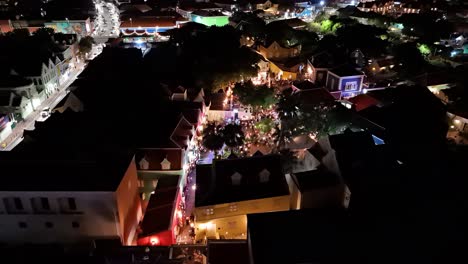 Panoramic-aerial-orbit-of-fashion-show-runway-down-Kura-Hulanda-village-in-Otrobanda-Willemstad-Curacao-at-night