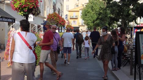 People-of-different-ages-move-around-in-Antibes-Old-Town,-static-shot