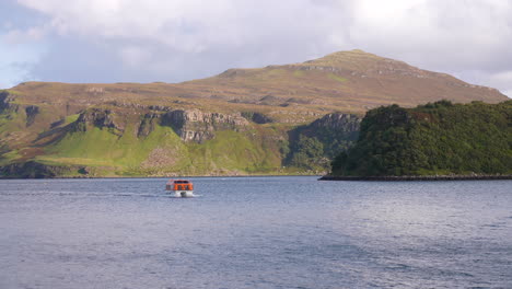 Isle-of-Skye,-Scotland-UK,-Scenic-Shoreline-and-Ferry-Boat-in-the-Sea,-Slow-Motion