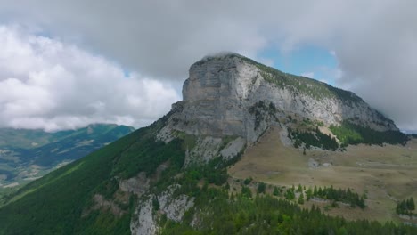 Approaching-mountain-summit-with-valley-on-pine-and-mount-Granier,-French-Alps