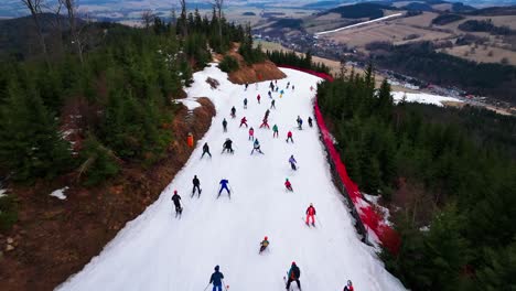 Aerial-view-of-skiers-go-downhill-on-Dolni-Morava-snowy-mountain-slope