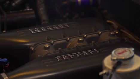 Close-up-shot-of-a-Ferrari-Engine-with-the-Ferrari-name-plate-lit-up