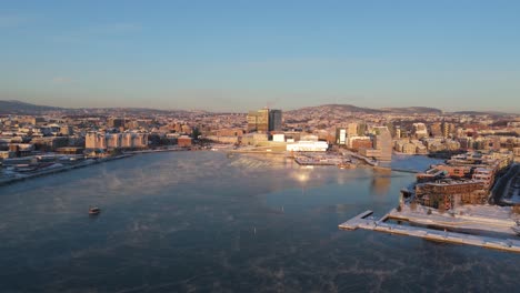 Golden-Hour-View-Over-Bjorvika-With-Sun-Light-Being-Reflected-Off-Oslo-Opera-House-In-Background
