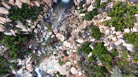 Aerial-View-of-Waterfall-with-graffiti-and-tagged-rocks-around-it