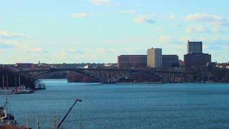 Wide-view-of-traffic-on-bridge-Vasterbron-over-water-in-Stockholm