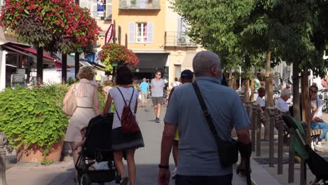 Man-with-crutch-and-other-people-walk-in-Antibes-Old-Town-in-2020