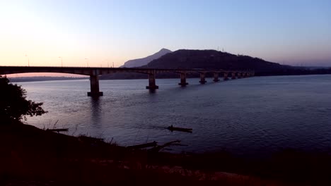 At-sunset,-the-majestic-Friendship-Bridge-stretches-over-the-Mekong-River,-offering-a-picturesque-scene