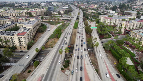 Los-Angeles-USA,-Aerial-View-of-Traffic-on-US-101-Highway,-Hollywood-Freeway-and-Interchange-by-Downtown-Apartment-Buildings