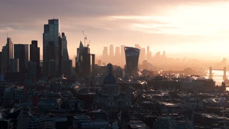 Aerial-slider-shot-of-central-London-with-Canary-wharf-in-the-background-at-sunrise