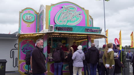 People-waiting-in-line-for-a-French-pancakes-or-crepes,-overcast-day-at-an-event