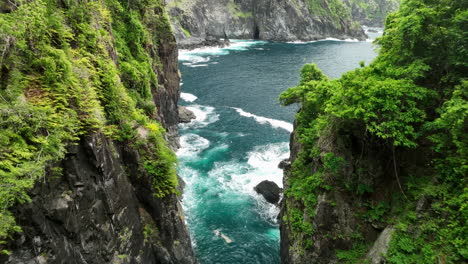 Aerial-views-through-valley-of-Orong-Bukal-cliff-jumping-location-on-Lombok-Island,-Indonesia