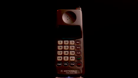 Vintage-Motorola-Pocket-Classic-1100-GSM-Mobile-Telephone-From-1990's,-Close-Up-Spinning