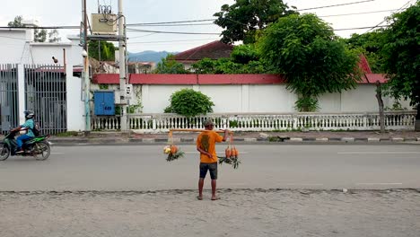 Local-Timorese-fruit-seller-selling-tropical-produce-in-the-capital-city-of-East-Timor,-Southeast-Asia