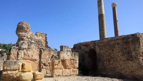 Ancient-Roman-columns-against-clear-blue-sky-in-Carthage,-Tunisia