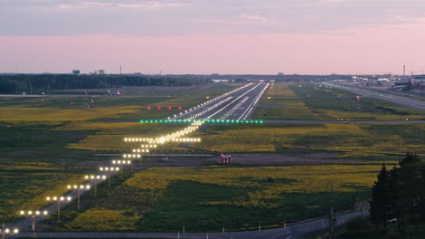 Flying-around-touchdown-zone-of-Tallinn-airport-runway-in-sunset-with-approach-lighting-turned-on-and-flashes-rolling