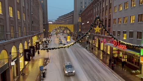 Twilight-view-of-Kungsgatan-adorned-with-Christmas-lights,-Stockholm