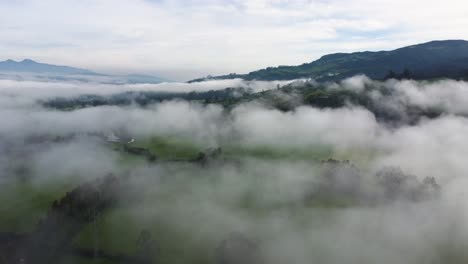 Cinematic-slow-aerial-drone-flying-through-the-clouds-over-the-mountains-in-Neblina,-Machachi,-Equador