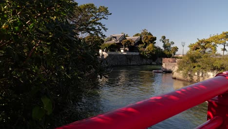 Stunning-view-out-on-Hayama-Shrine-in-Japan-with-red-bridge-in-foreground