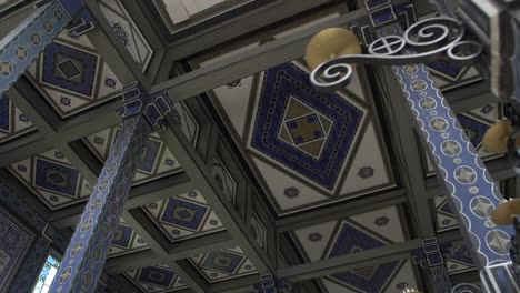 ceiling-decoration-in-memorial-church-Javorca-in-Slovenia,-interior-dolly-cinematic