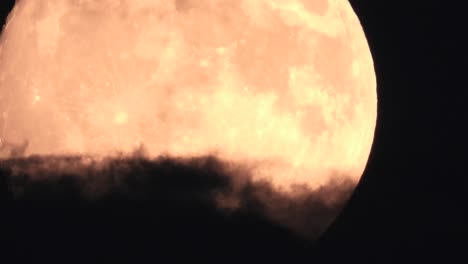 Orange-Full-Moon-Timelapse-with-Dark-Spooky-Clouds-in-Foreground