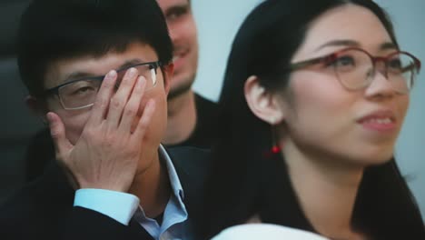 Close-up-of-gentle-face-of-Asian-female-and-male-student-with-glasses-in-classroom