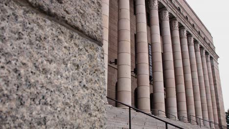 Angled-view-of-the-grand-Helsinki-Parliament-House-facade,-imposing-columns,-overcast-sky