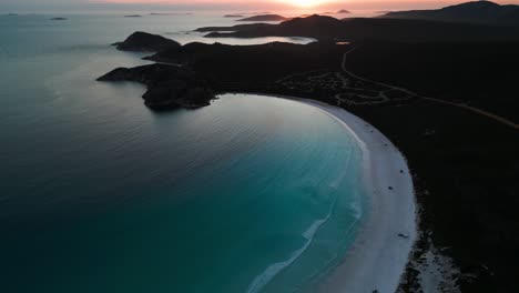 aerial-view-revealing-lucky-bay-and-the-campground-in-Cape-Legrand-National-Park-at-sunset,-western-australia
