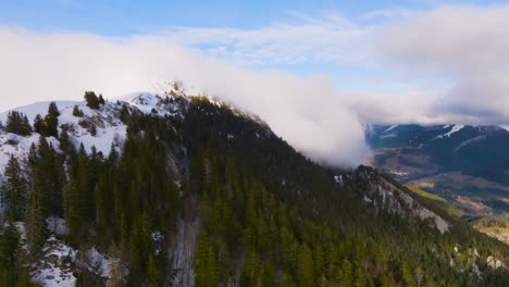 Flying-to-strange-falling-cloud-over-mountain-valley-with-snow-and-pine